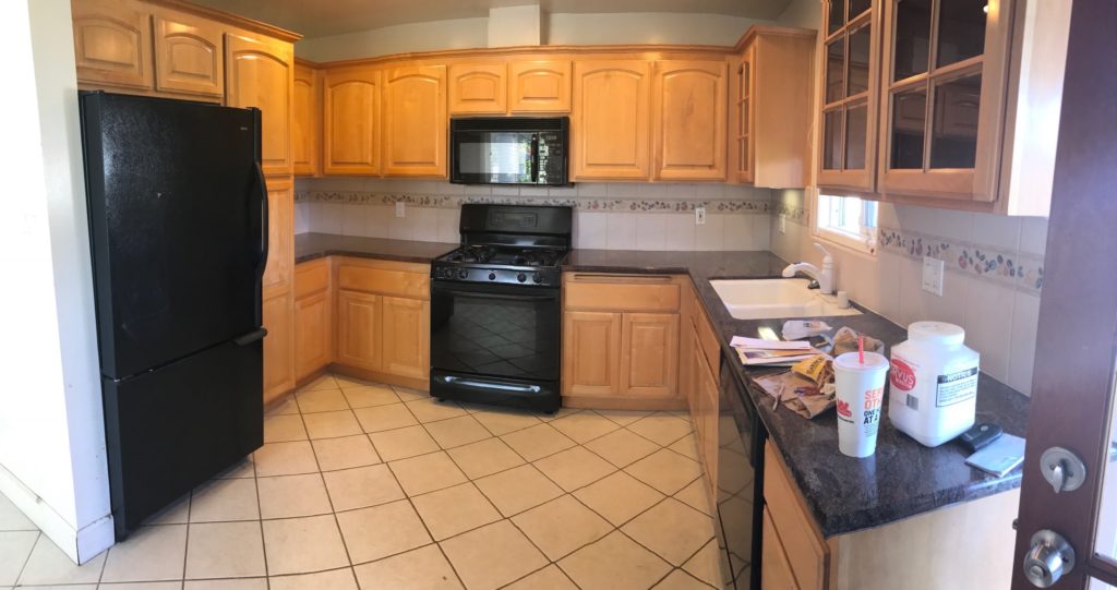 kitchen with maple cabinets and black appliances