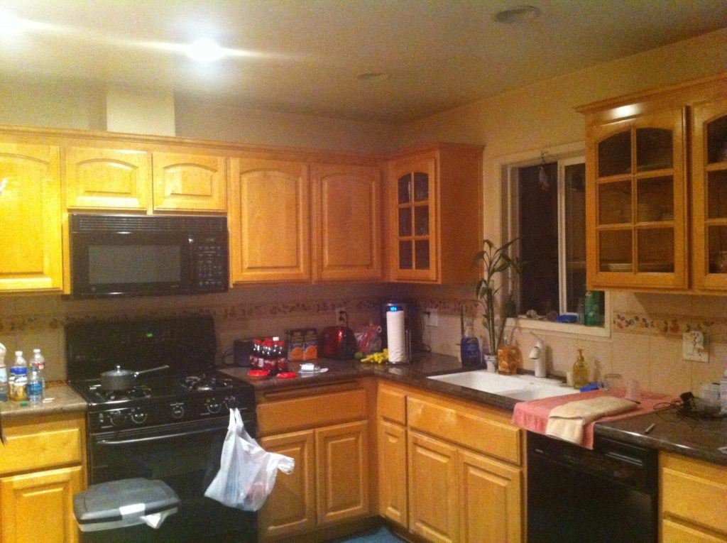 kitchen with maple cabinet color and black appliances