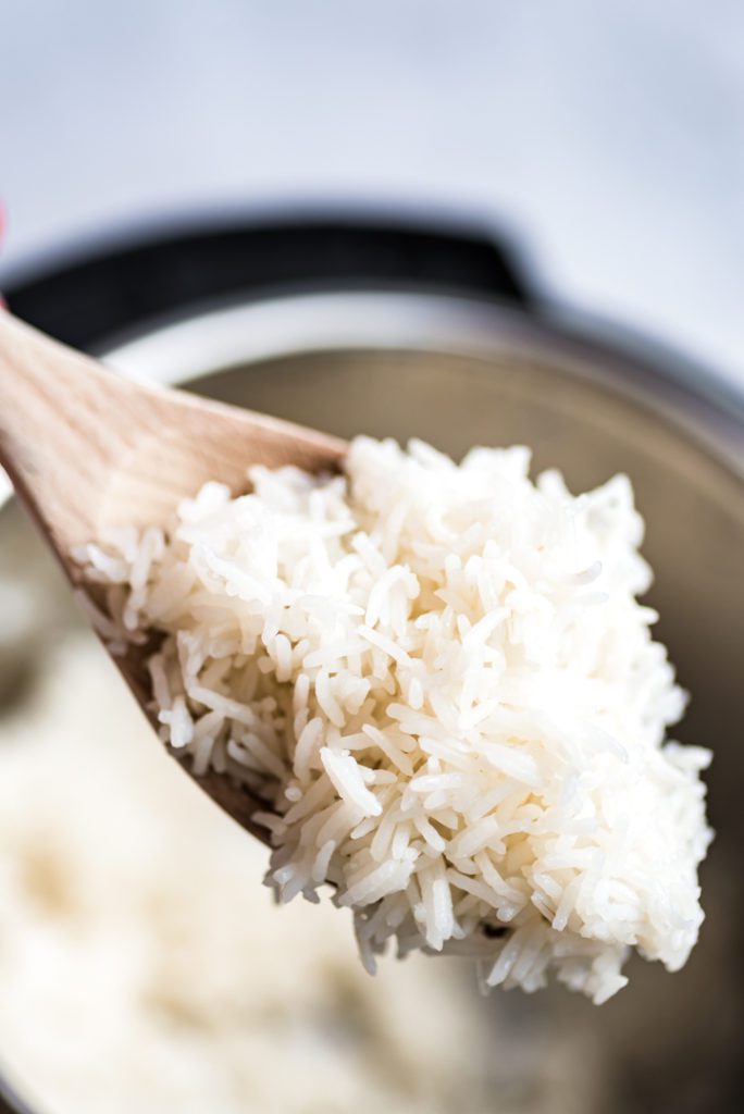 White rice on wooden spoon