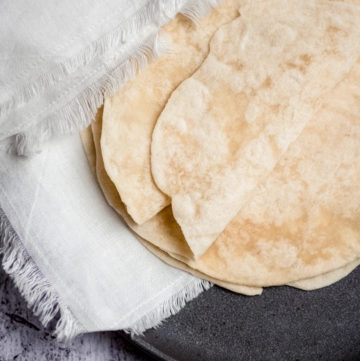 flour tortillas on a plate with napkin