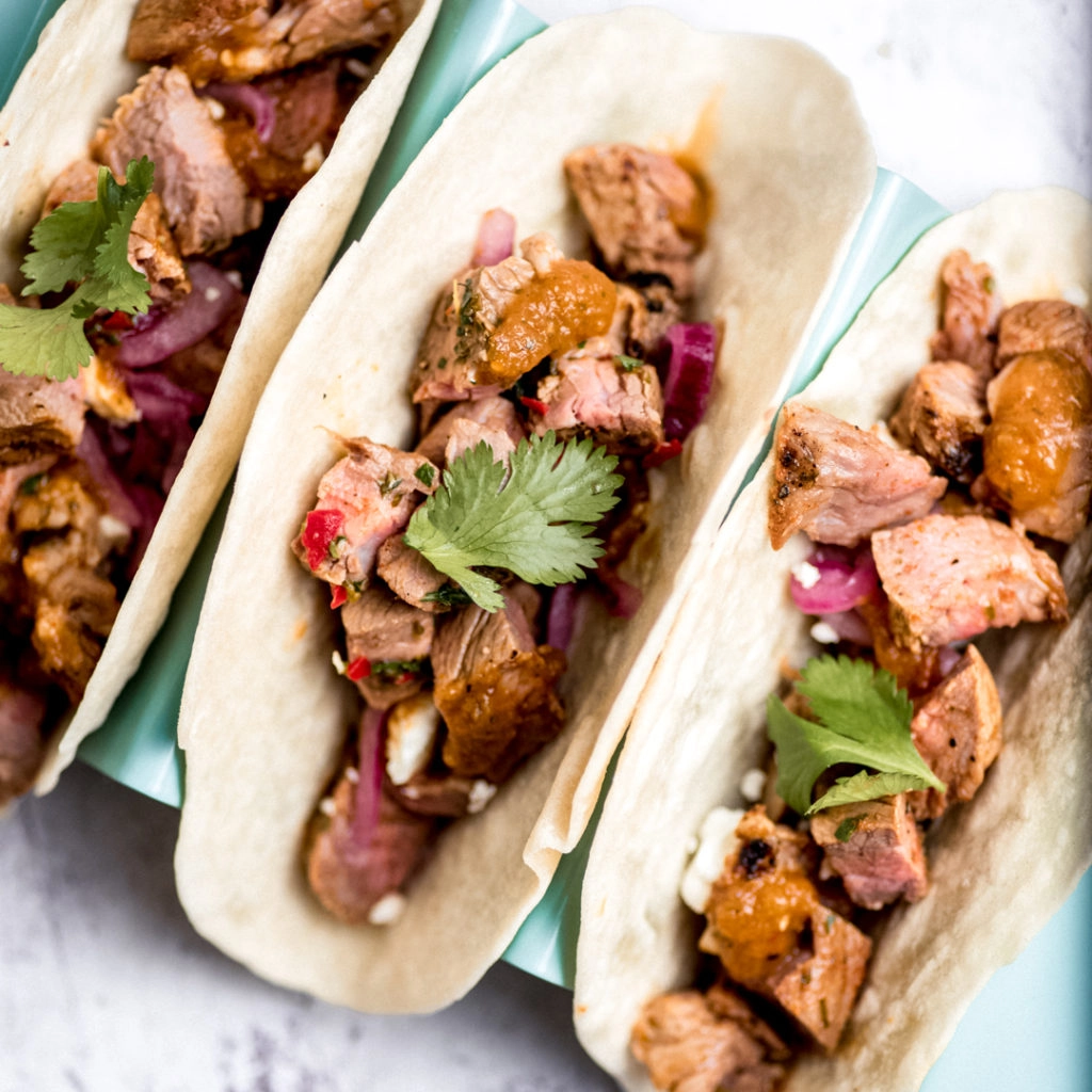 Carne asada tacos on flour tortillas