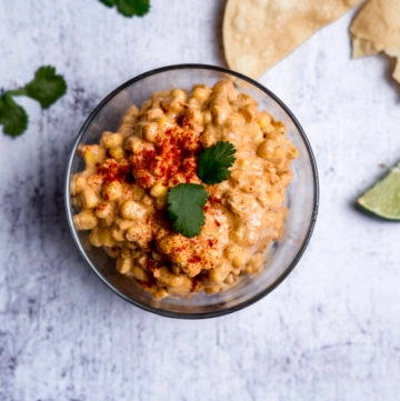 elote in a bowl with chips and cilantro