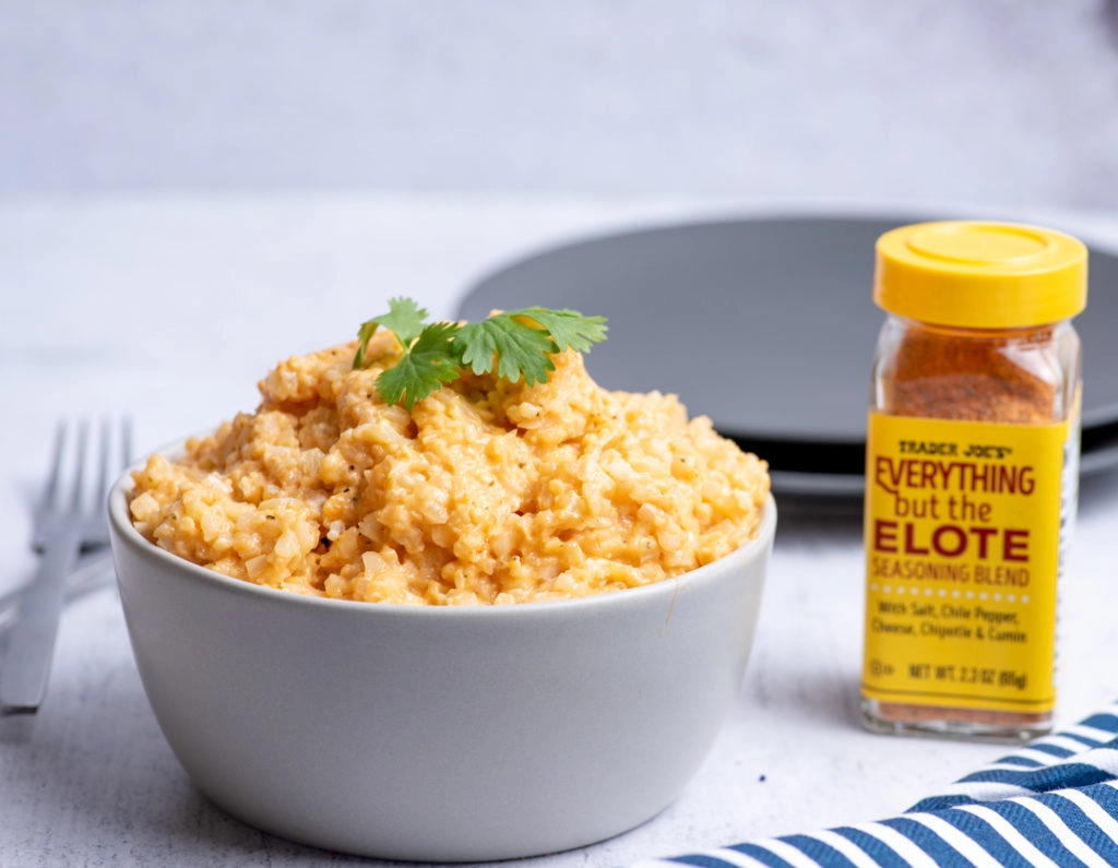 riced cauliflower in a bowl with elote seasoning