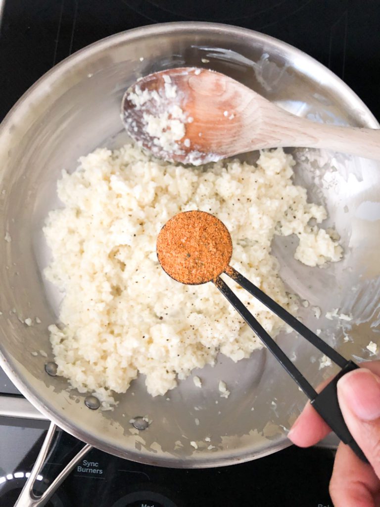 spoon over pan with seasoning
