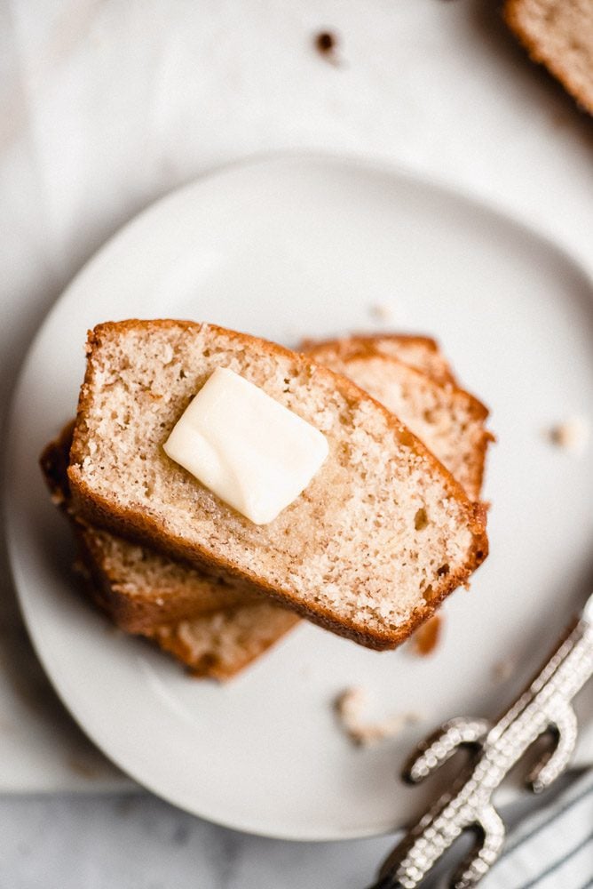 Banana bread slices on plate with butter on top