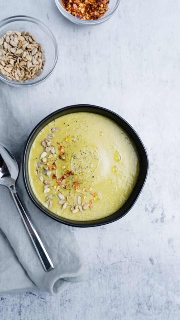 vegan asparagus soup with chili flakes and sunflower seeds