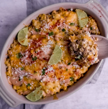 Corn casserole in baking side with wooden spoon