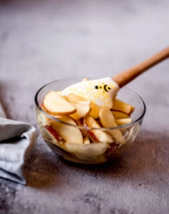 apple slices in bowl with lemon and sugar