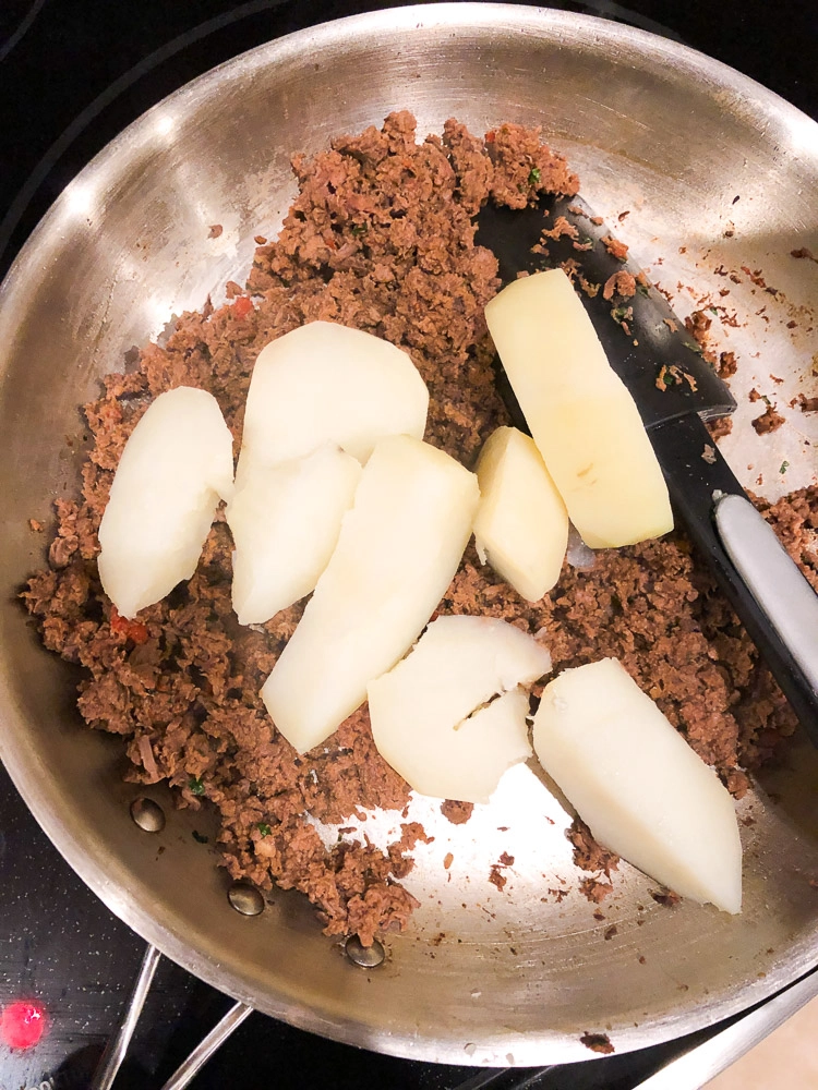 ground meat and potatoes on a skillet