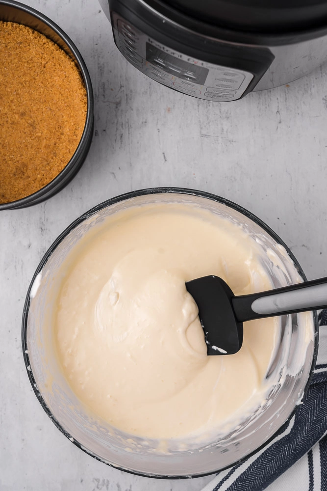 cheesecake batter with spatula in bowl