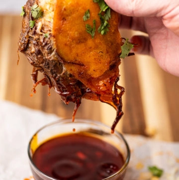 stuffed corn tortilla with meat and cheese, dipped in au jus