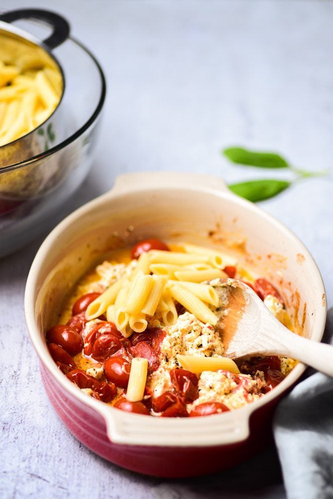 Baked feta cheese with pasta on baking dish