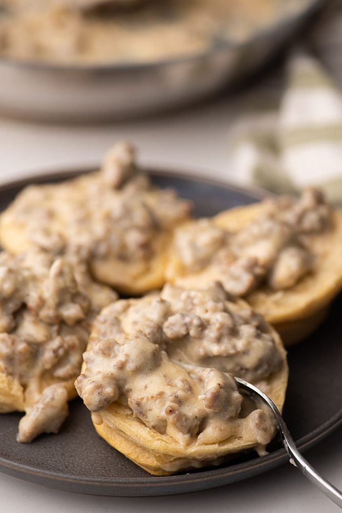 Biscuits with gravy on a plate with fork
