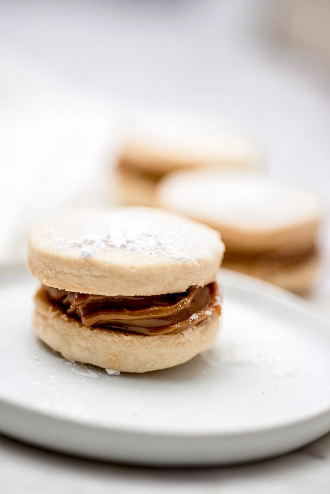 Alfajor cookie sandwich on a white plate