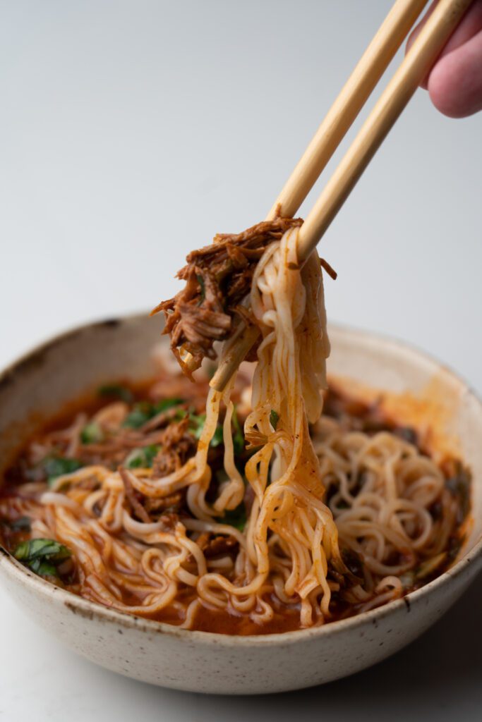 Birria ramen on a bowl with chopsticks