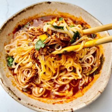 Birria ramen with chopsticks