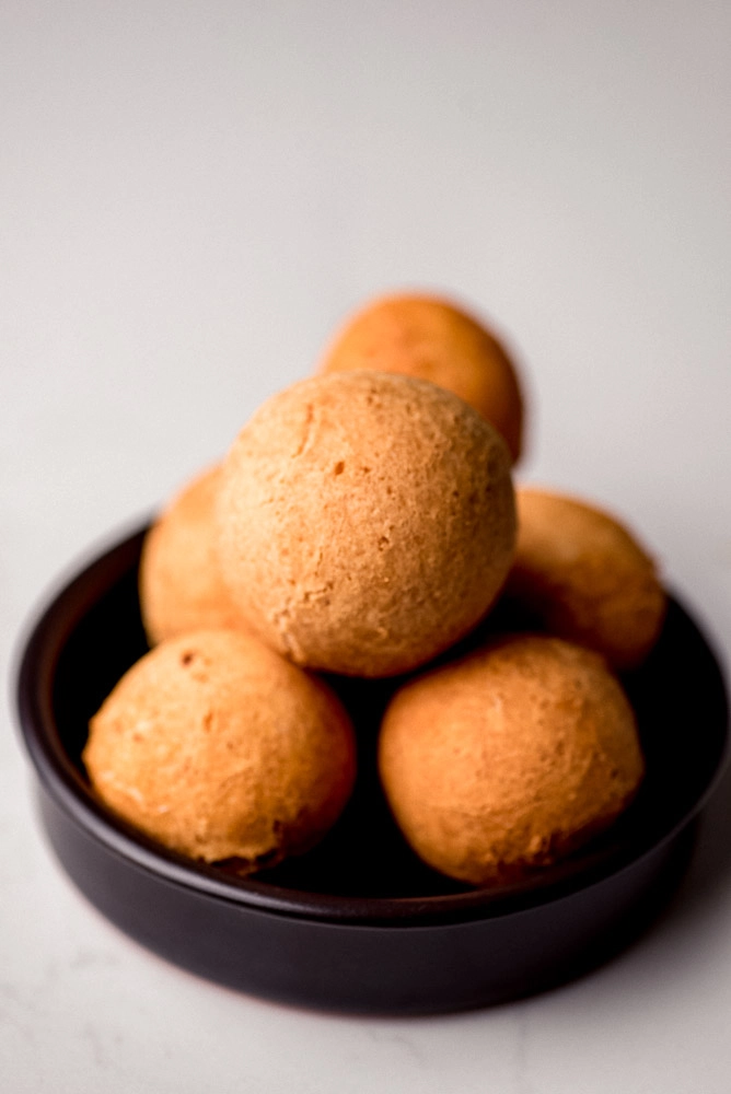 buñuelos pilled up on a plate