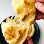 Colombian arepas with cheese pull on a blue plate
