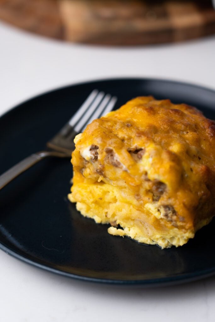 breakfast casserole slice on a plate with fork