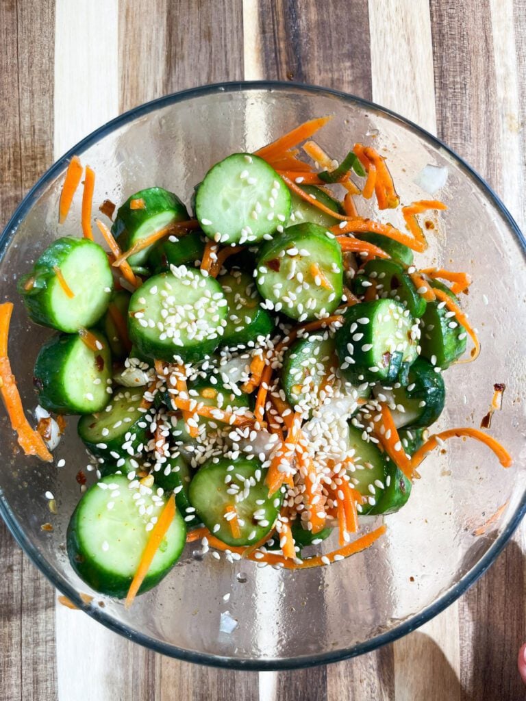 Asian cucumber salad with carrots, sesame seeds and onions