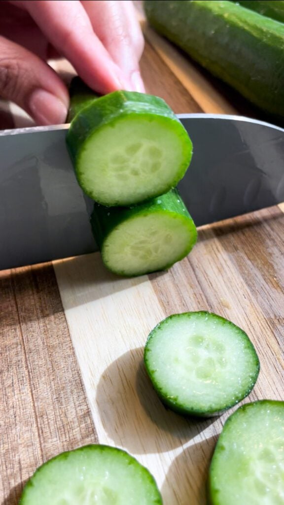 cucumbers on a board with knife
