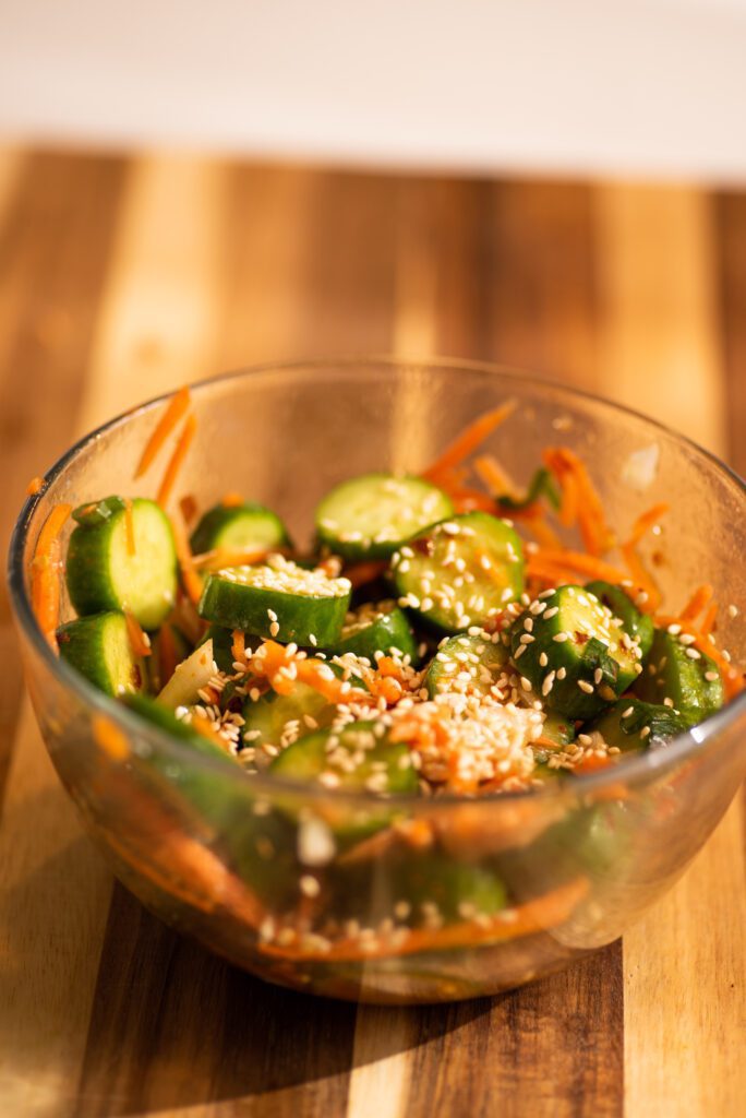 cucumber salad with onion, carrots, sesame seeds on a bowl