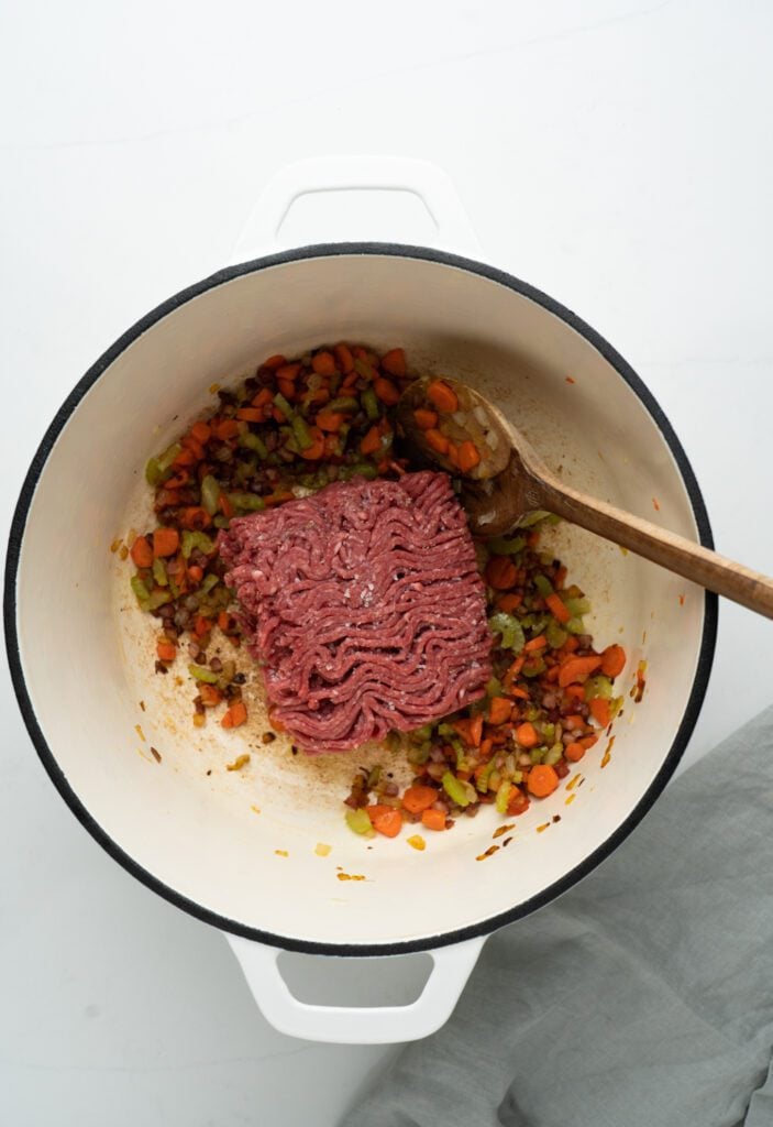 beef in a pot with mirepoix