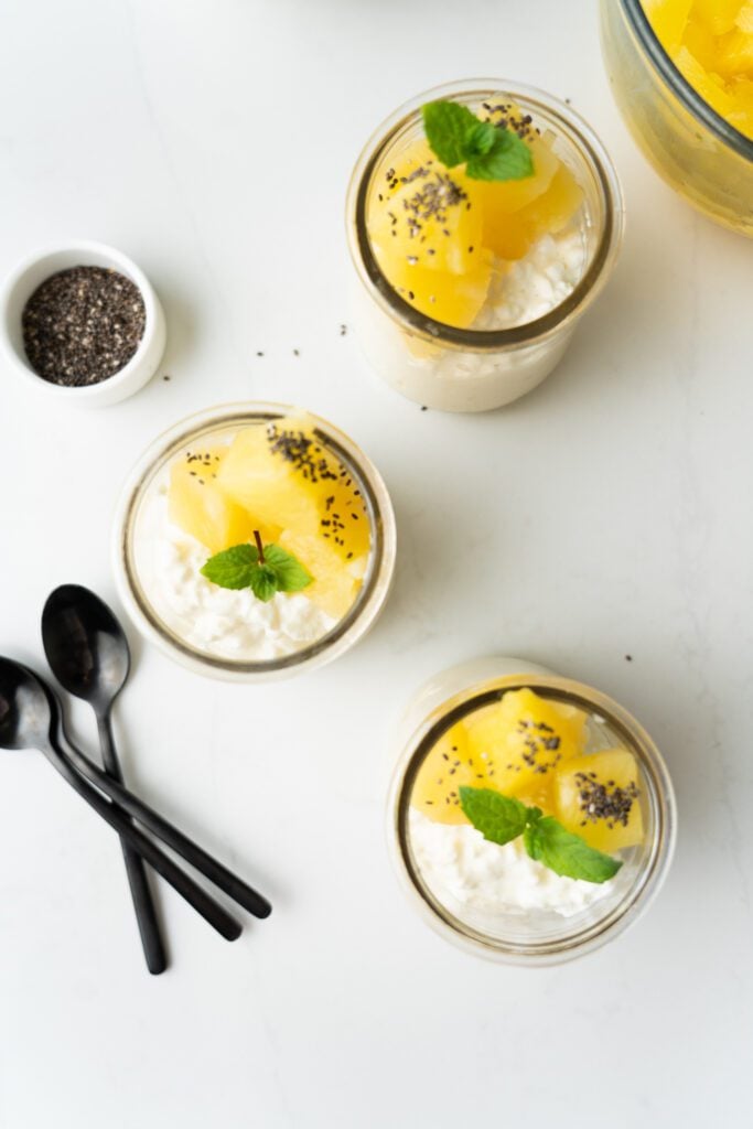 Cottage cheese on glass jars with pineapple, chia and mint