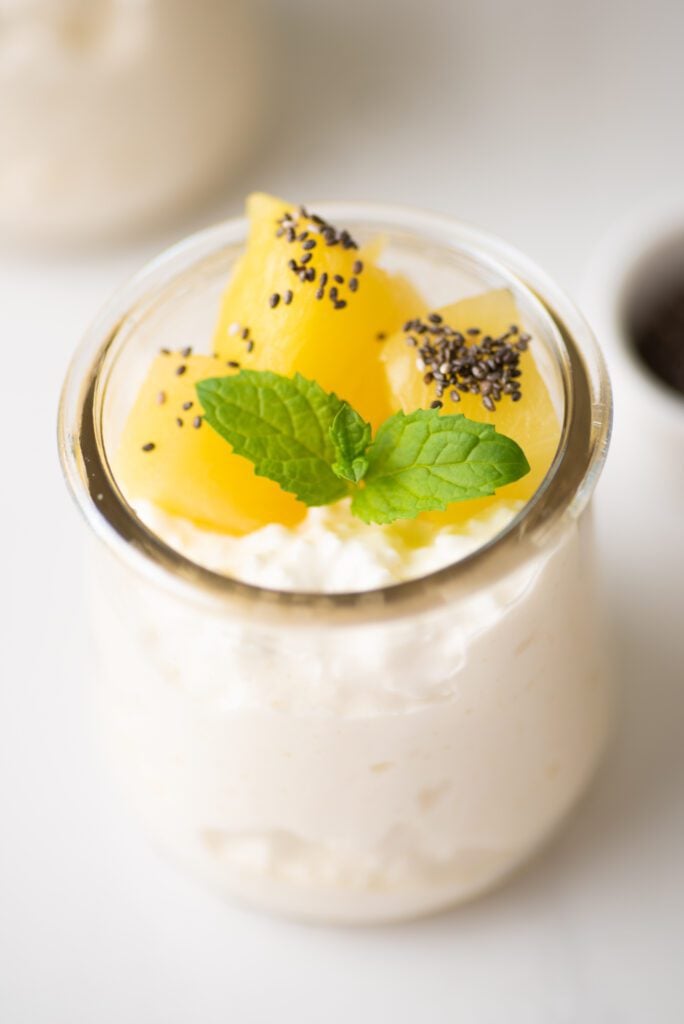 Cottage cheese on glass jars with pineapple, chia and mint