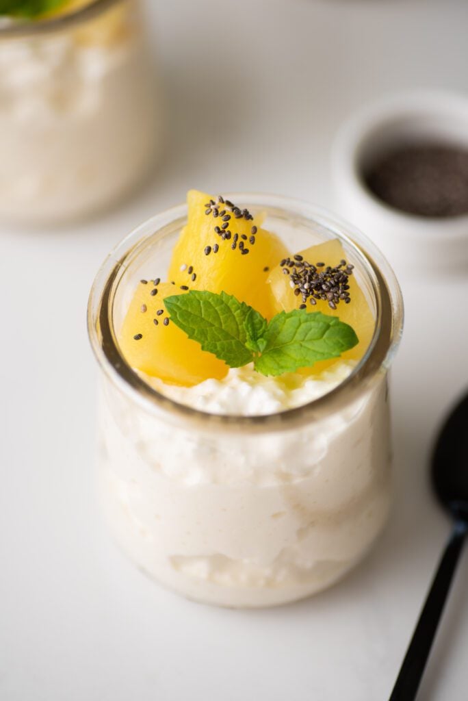 Cottage cheese on glass jars with pineapple, chia and mint