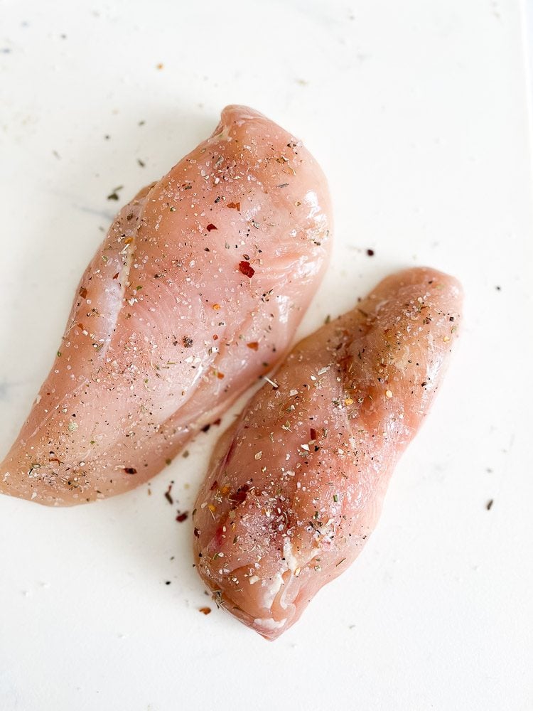 raw chicken breast with seasoning