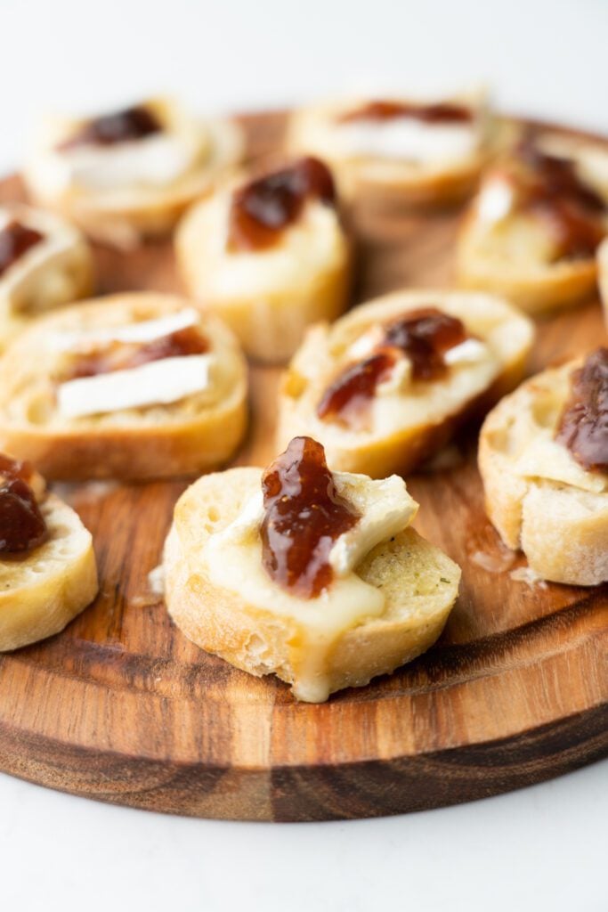 Fig and brie on crostini served on a wood board