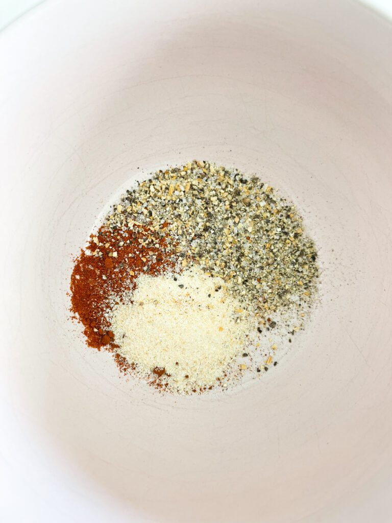 paprika, onion powder and lemon pepper seasoning in a bowl