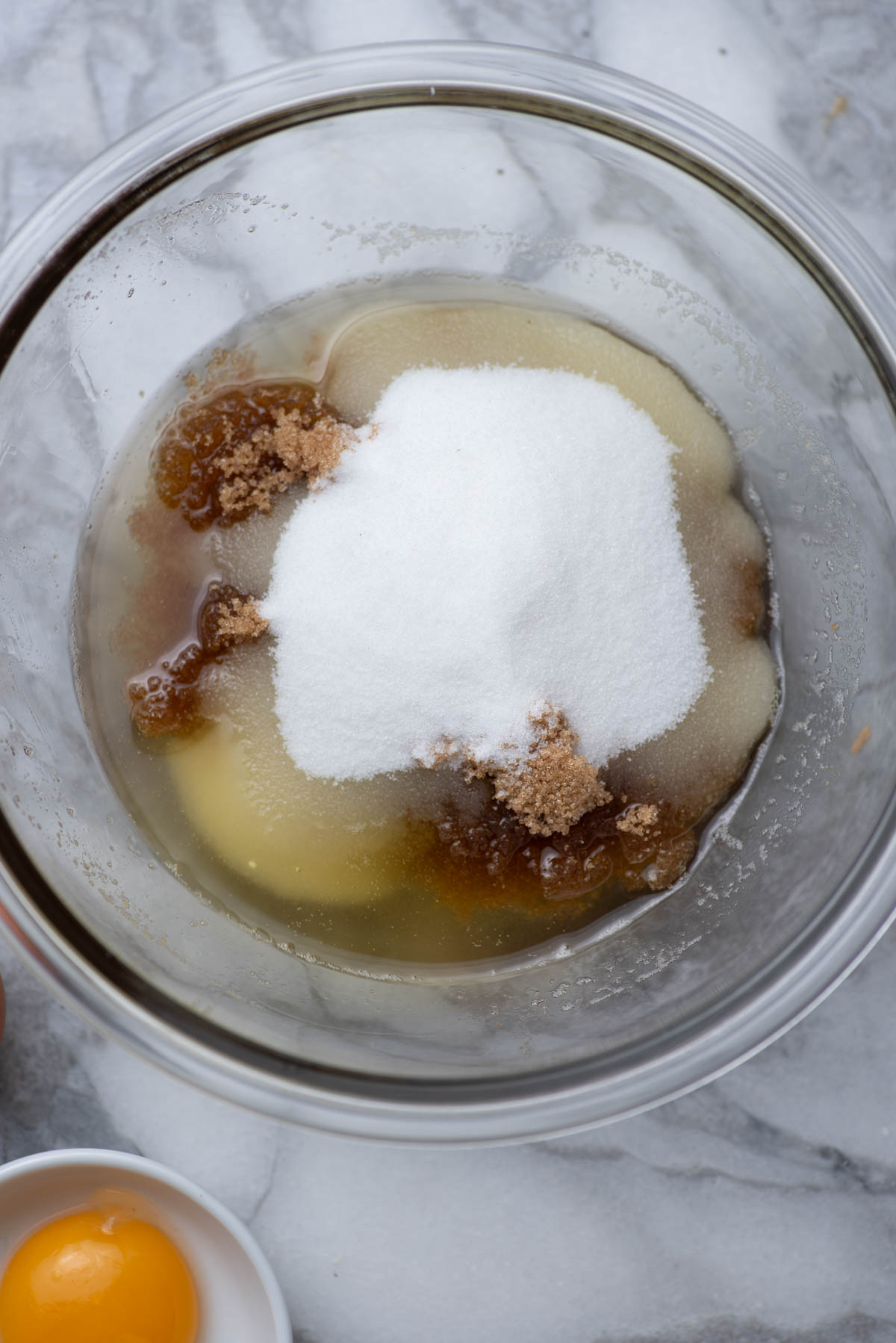 Melted butter with brown sugar and granulated sugar in a bowl.