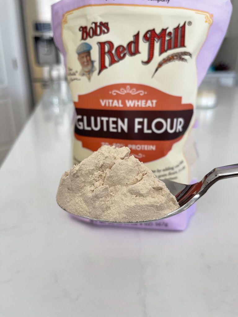 gluten flour scooped out of bag