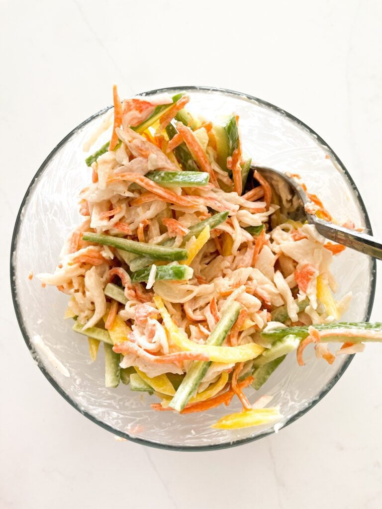 crab, cucumber, avocado and mango salad on a bowl