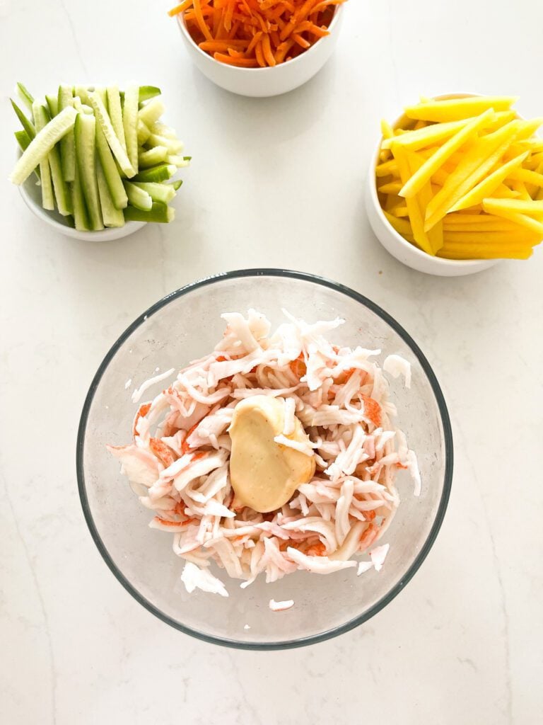 crab, cucumber, and mango salad on a bowl