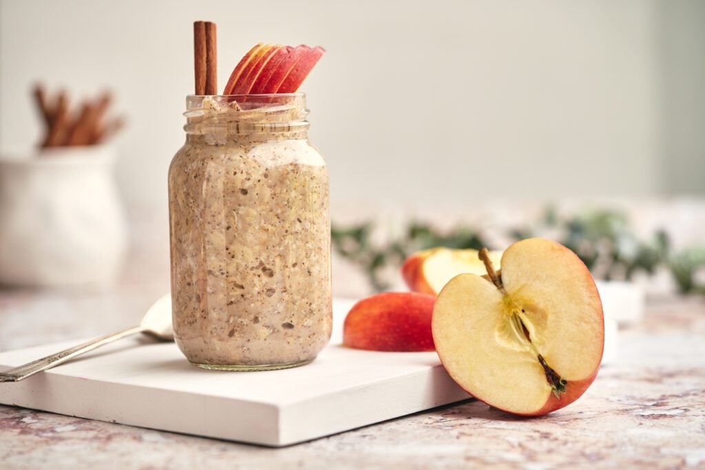 overnight oats in glass jar with apple and cinnamon