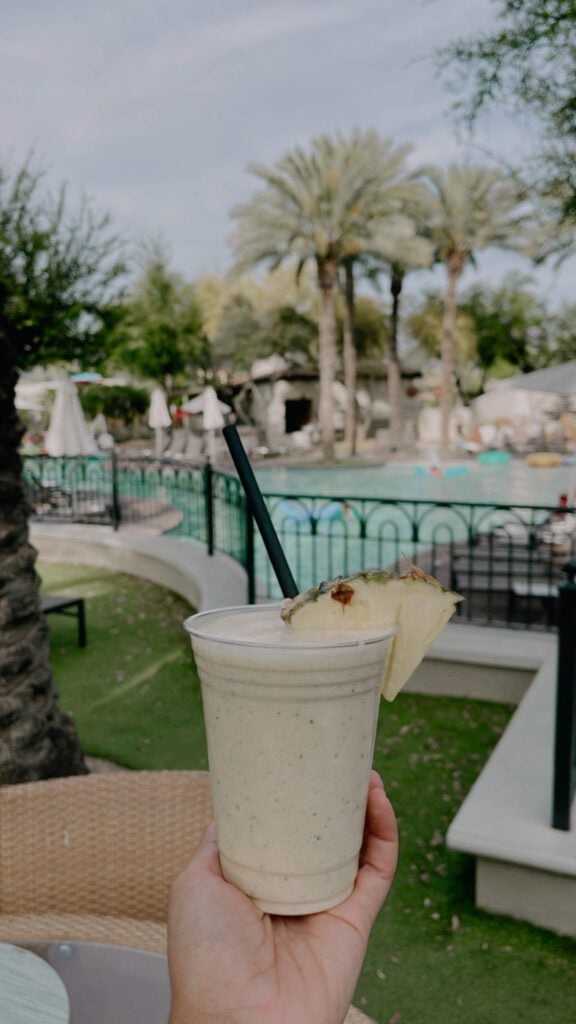 mojito drink with the pool in the background