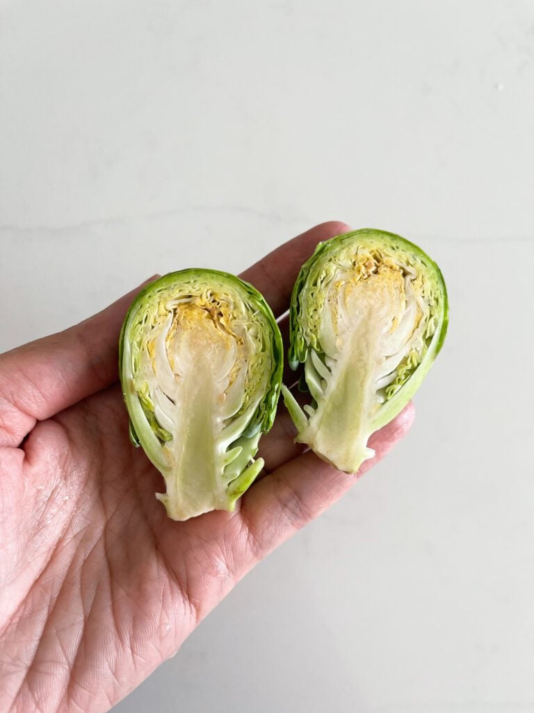 hand holding cut Brussel sprouts