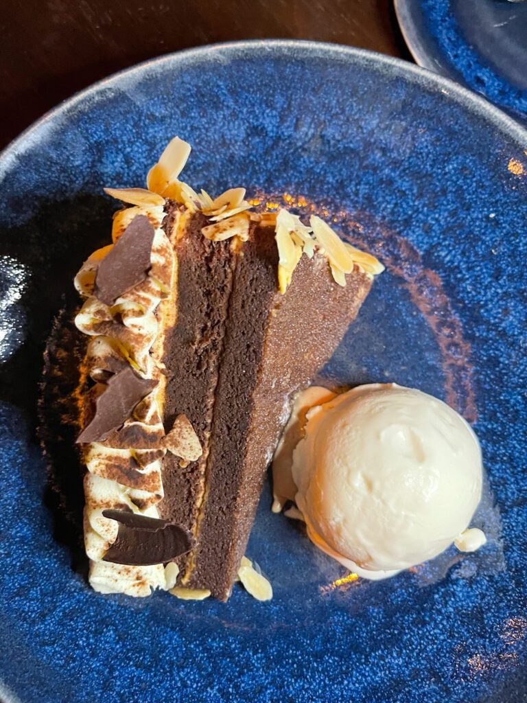 chocolate cake on blue plate with ice cream 