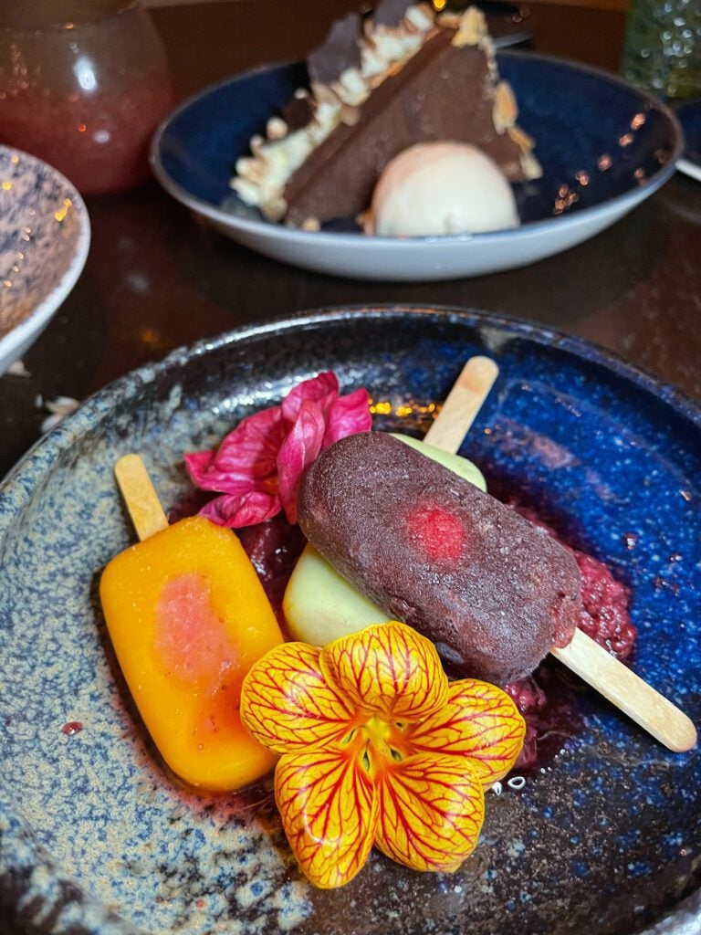 Paletas on a dish with flower garnish