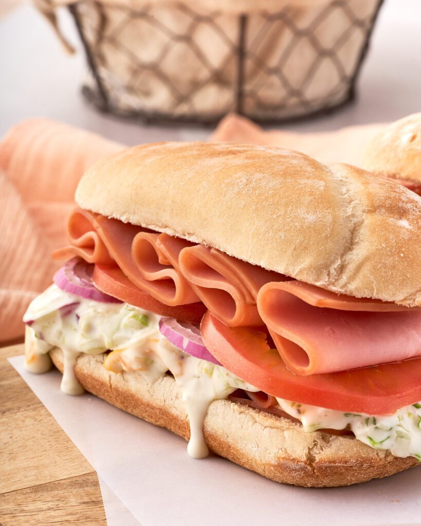 sandwich with cold cuts, tomatoes and creamy dressing