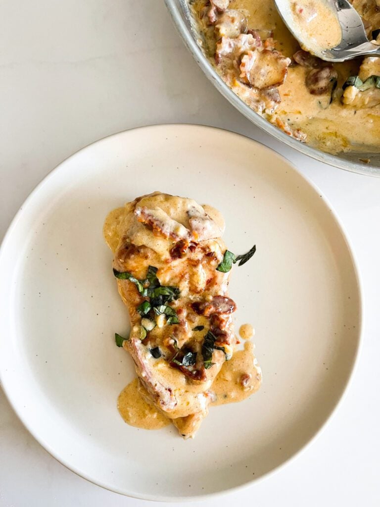 overhead view of plated chicken with pan sauce