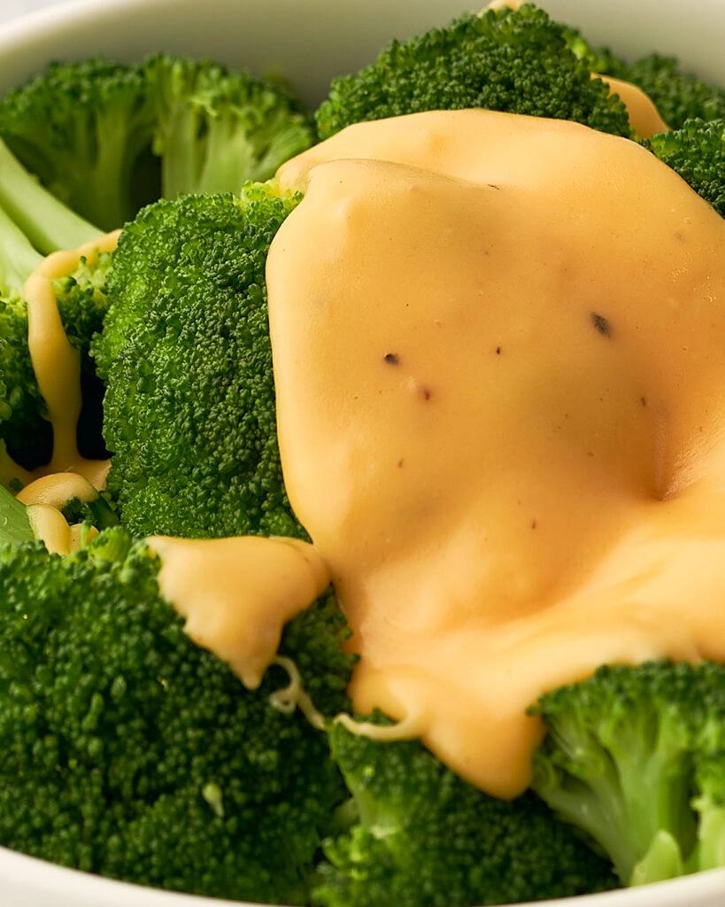 close up view of the broccoli with cheese sauce