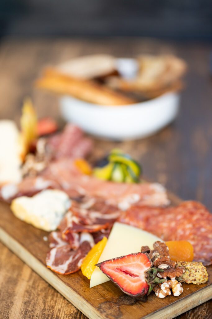 meat and cheese on wooden board