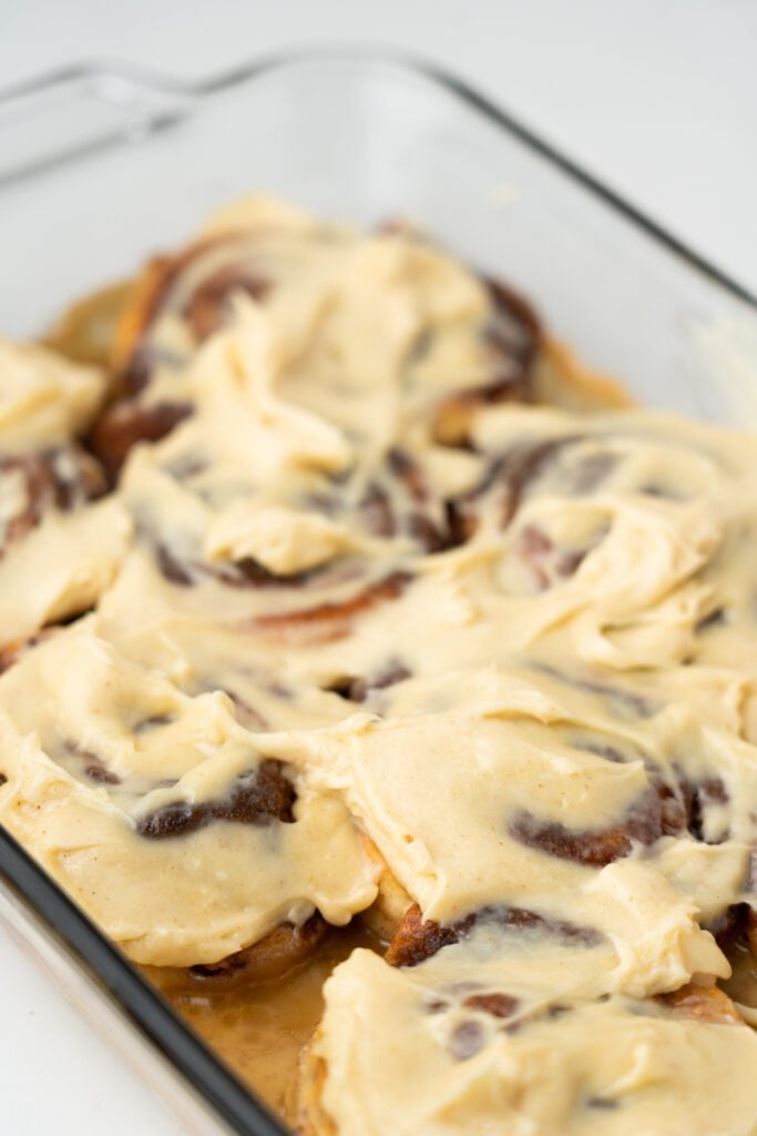 cinnamon rolls with icing in baking dish