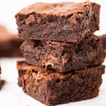 Triple chocolate brownies in a stack.