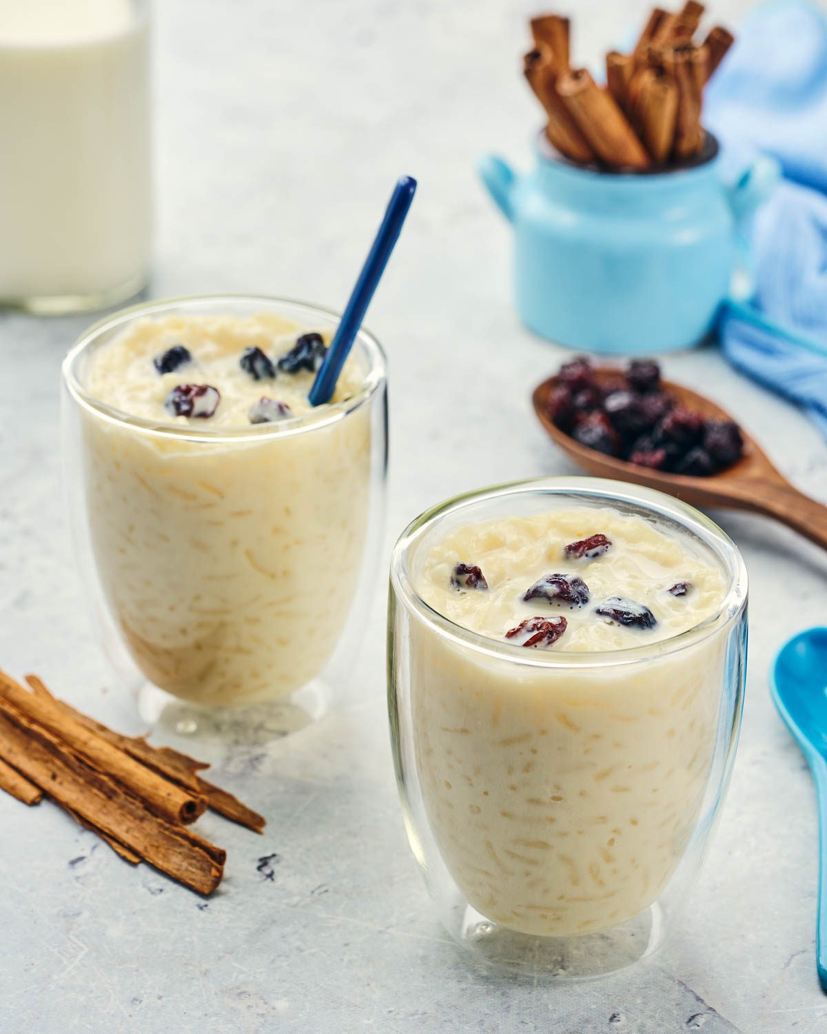 Rice pudding served in glass cups with raisins and cinnamon