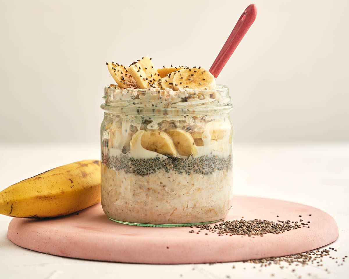 overnight oats in a jar with chia seeds and sliced bananas.